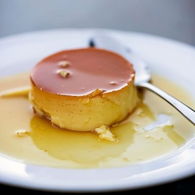Small piece of Leche Flan on a plate Small piece of Leche Flan on a plate